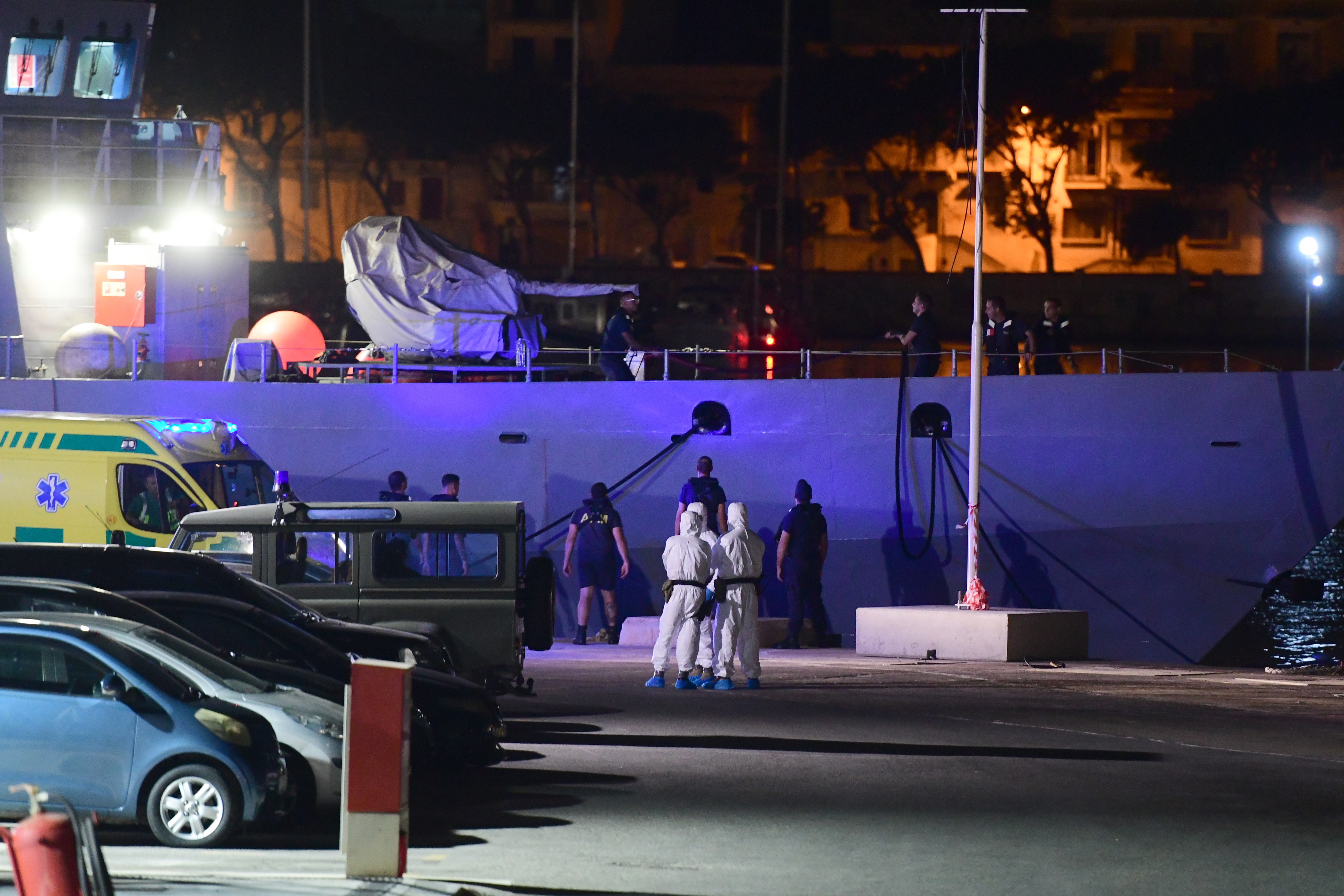 epa07789530 Officials on board an AFM vessel after some 356 migrants, who had been stranded on the NGO rescue ship Ocean Viking for 13 days in the Mediterranean, arrived at Hay Wharf maritime base in Floriana, Malta, late 23 August 2019 (issued 24 August 2019). Some 356 African migrants aboard the rescue ship Ocean Viking migrants will be re-distributed to six other EU states (France, Germany, Ireland, Luxembourg, Portugal and Romania), the Maltese government said.  EPA/STRINGER
