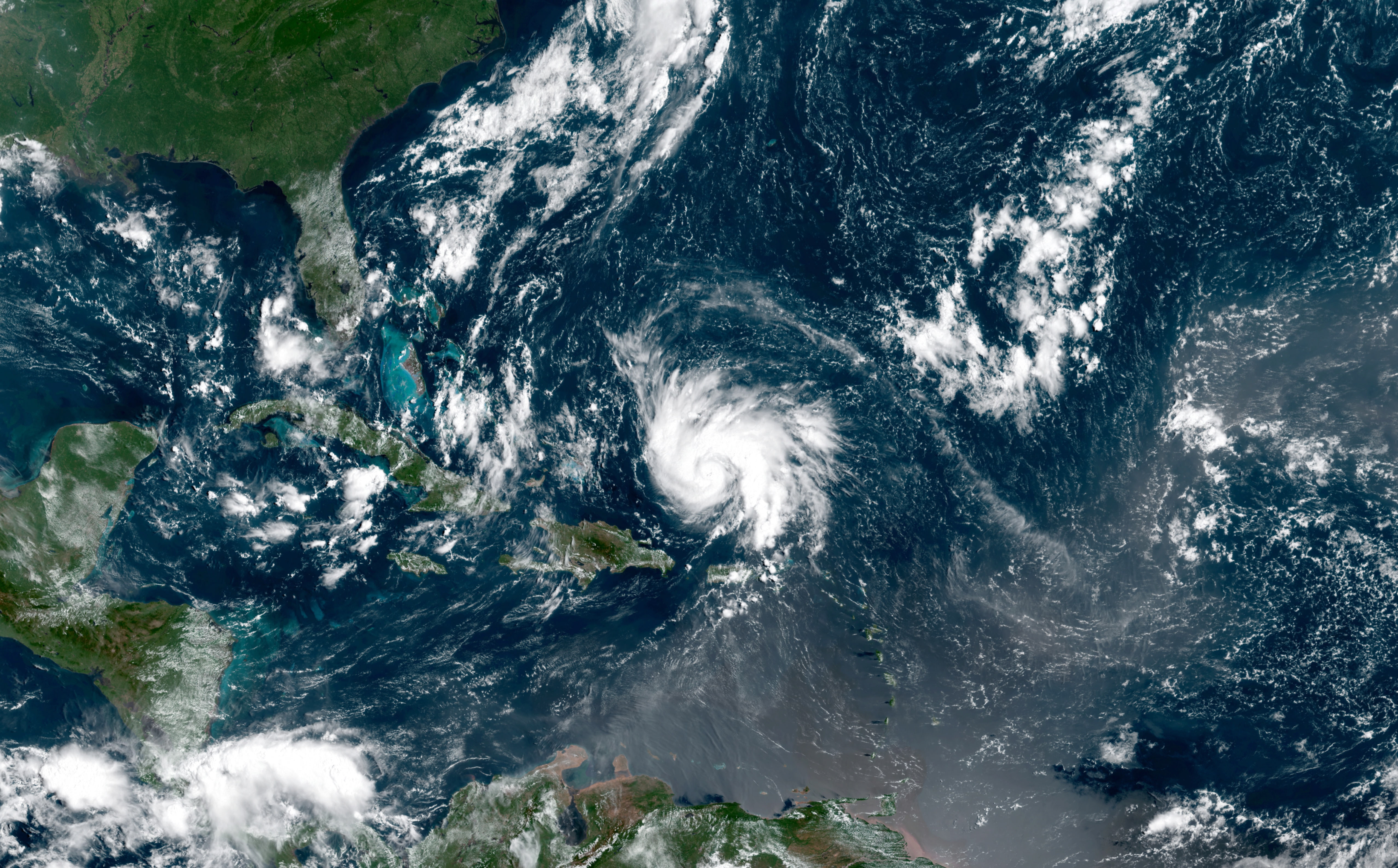 epa07804296 A handout composite satellite photo dated 29 August 2019 and made available by NASA Earth Observatory shows category two Hurricane Dorian as it passes the east coast of Puerto Rico, 29 August 2019 in an image with data acquired by the Geostationary Operational Environmental Satellite 16 (GOES-16). The US National Hurricane Center reported sustained winds of 85 miles (140 kilometers) per hour. Florida governor Ron DeSantis has declared on 28 August a state of emergency in Florida as Dorian could make landfall as a category 3 hurricane over the weekend.  EPA/NASA EARTH OBSERVATORY HANDOUT  HANDOUT EDITORIAL USE ONLY