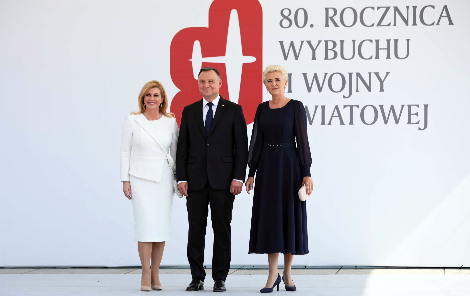 epa07809509 Polish President Andrzej Duda (C) and his wife Agata Kornhauser-Duda (R) welcome Croatian President Kolinda Grabar Kitarovic (L) during official welcome ceremony at the Jozef Pilsudski Square for the ceremony marking 80th anniversary of World War II outbreak in Warsaw, Poland, 01 September 2019. The Luftwaffe attack on the Polish city of Wielun in the early morning of 01 September 1939 marked the beginning of World War II. A few minutes later, the German battleship SMS Schleswig-Holstein bombarded the Gdansk Westerplatte.  EPA/LESZEK SZYMANSKI POLAND OUT