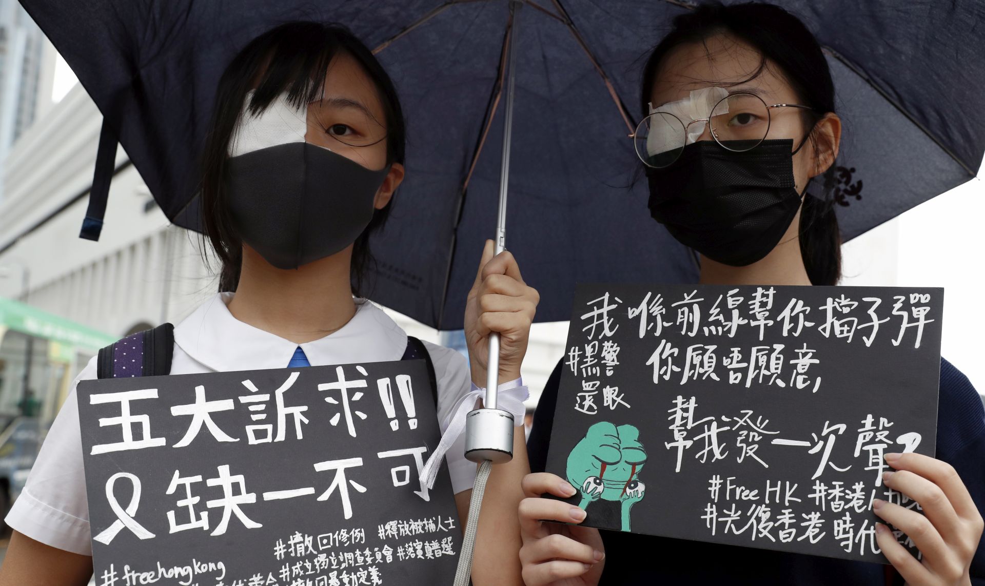 epa07811947 Secondary school students hold placards with five core demands as they gather in support of the ongoing pro-democracy protests, at Edinburgh Place in Central, Hong Kong, China, 02 September 2019. Hong Kong has been gripped by mass protests since June over a now-suspended extradition bill, which have since morphed into a wider anti-government movement.  EPA/JEON HEON-KYUN