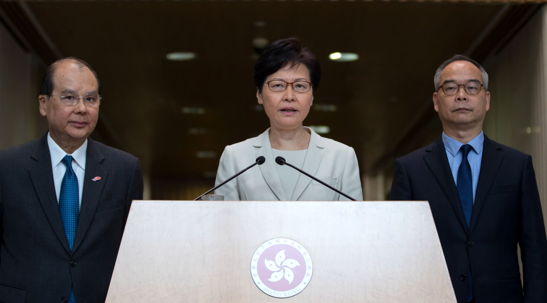 epa07818324 Hong Kong Chief Executive Carrie Lam (C) attends a press conference flanked by Matthew Cheung Kin-chung (L), Chief Secretary for Administration and Lau Kong-wah (R), Secretary for Home Affairs of Hong Kong Government, at the central government offices in Hong Kong, China, 05 September 2019. Lam announced the withdrawal of a controversial extradition bill, which sparked months of large protests and unrest in Hong Kong.  EPA/JEROME FAVRE