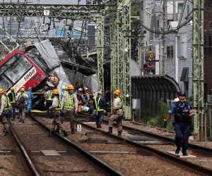 epa07818285 Rescuers and workers gather next to a train after it collided with a truck at a rail crossing in Yokohama, near Tokyo, Japan, 05 September 2019. According to media reports, about 33 people were injured in the collision.  EPA/JIJI PRESS JAPAN OUT EDITORIAL USE ONLY/  NO ARCHIVES