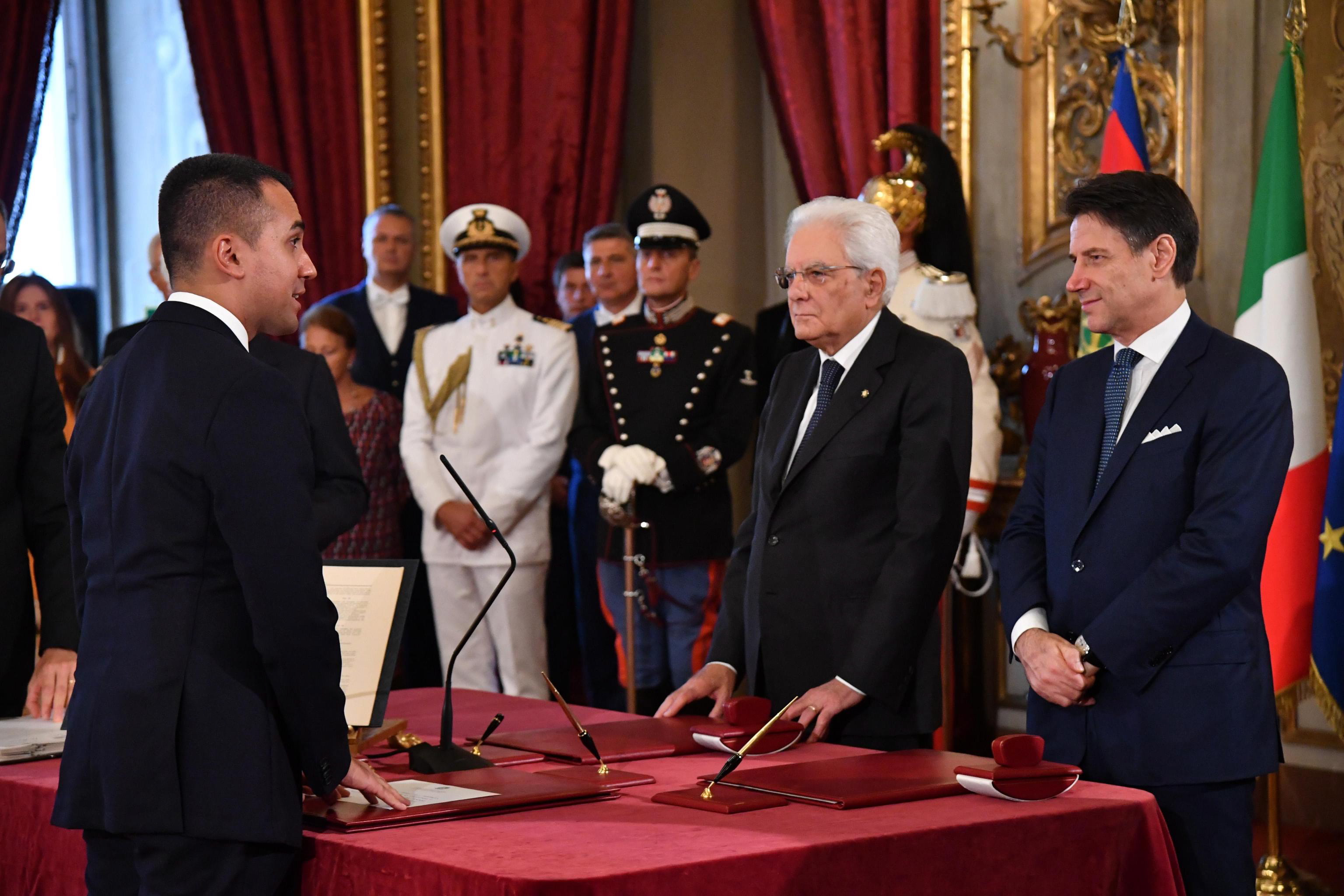 epa07818661 Italian Minister of Foreign Affairs Luigi Di Maio (L) stands in front of Italian Premier Giuseppe Conte (R) and President Sergio Mattarella (C) during the new government's swearing-in at Quirinal Palace, Rome, Italy, 05 September 2019. Italian Prime Minister Giuseppe Conte's new government is a coalition between the anti-establishment 5-Star Movement (M5S) and the center-left Democratic Party (PD) that will have 21 ministers, 10 from the M5S, nine from the PD and one from the small leftwing Free and Equal (LeU) party, media reported.  EPA/ALESSANDRO DI MEO