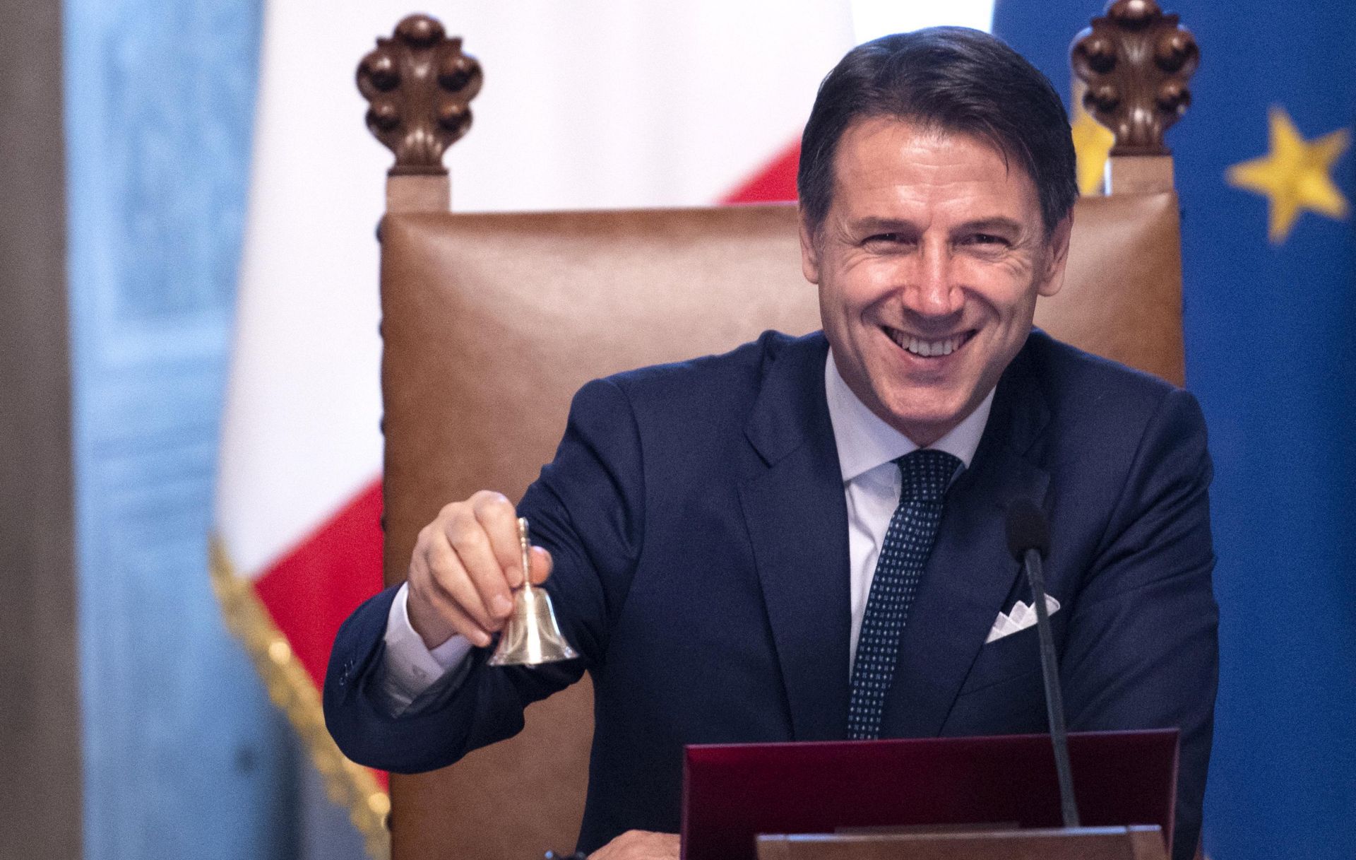 epaselect epa07819226 Italy's Prime Minister Giuseppe Conte rings the bell that traditionally opens the meeting of the cabinet at Chigi Palace in Rome, Italy, 05 September 2019. Conte's new government is a coalition between the anti-establishment 5-Star Movement (M5S) and the center-left Democratic Party (PD) that will have 21 ministers, 10 from the M5S, nine from the PD and one from the small leftwing Free and Equal (LeU) party, media reported.  EPA/MAURIZIO BRAMBATTI