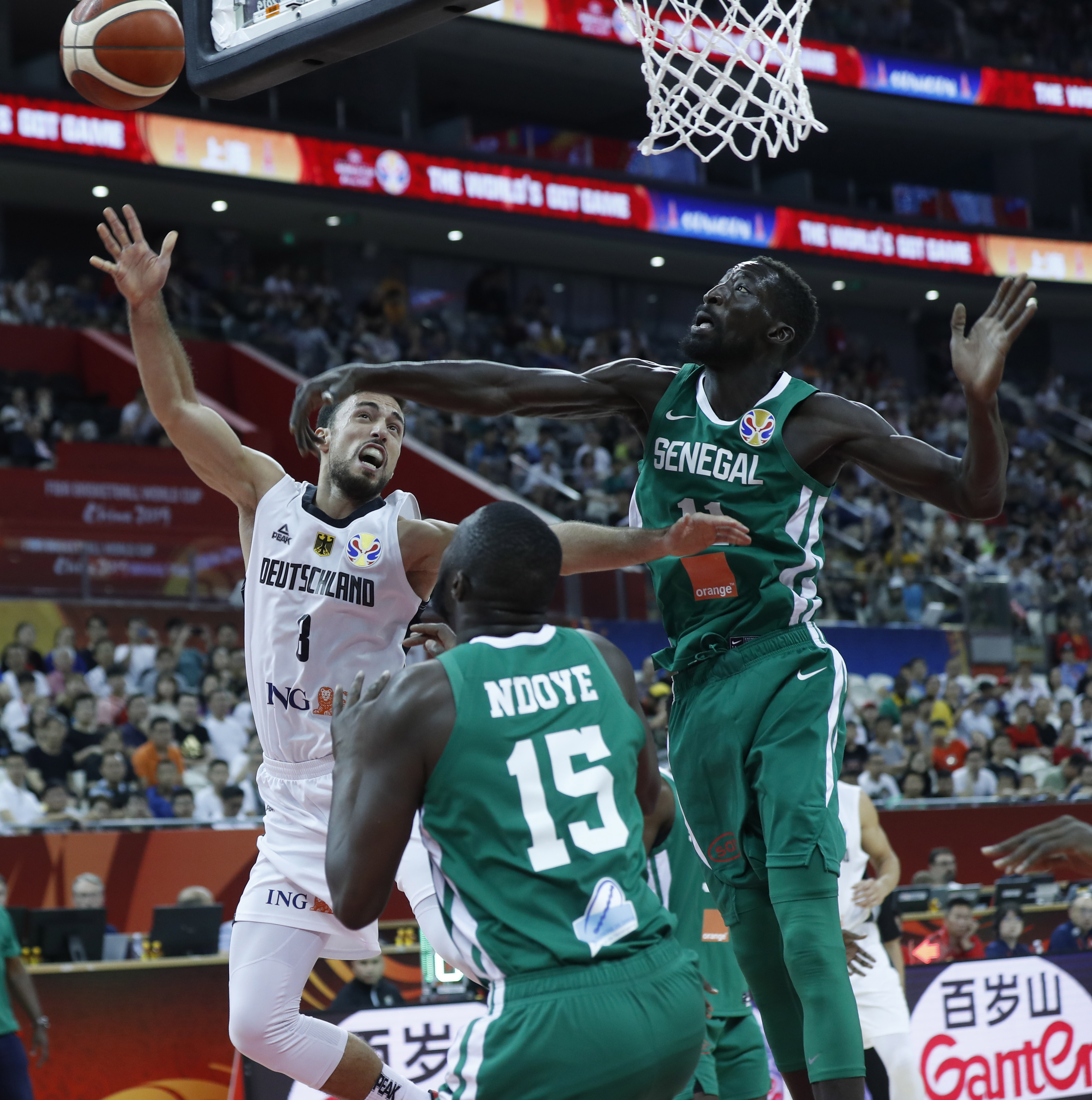 epa07825123 Ismet Akpinar of Germany (L) in action against Mouhammad Faye of Senegal (R) during the FIBA Basketball World Cup 2019 classification ​round​ match between Germany and Senegal in Shanghai, China, 07 September 2019.  EPA/WU HONG