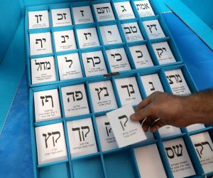 epa07836747 A worker of the Central Election Commission in Israel shows an election note in a sample voting position as part of preparations for the upcoming Israeli legislative elections, in Shoham, Israel, 12 September 2019. Israeli legislative election will be held on 17 September.  EPA/ABIR SULTAN