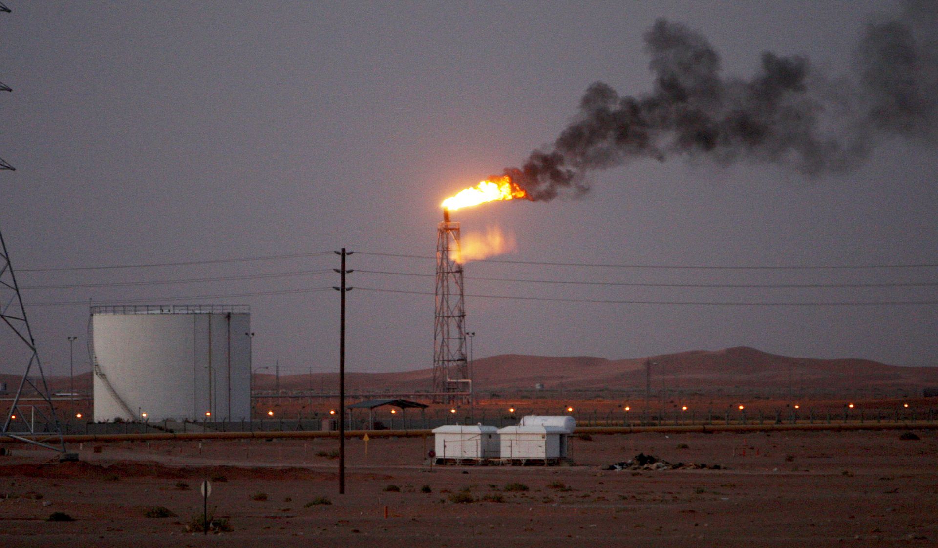epa07841156 (FILE) - A gas flame behind pipelines in the desert at Khurais oil field, about 160 km from Riyadh, Kingdom of Saudi Arabia, 23 June 2008 (reissued 14 September 2019). According to Saudi state-owned oil company Aramco, two of its oil facilities in Saudi Arabia, Khurais and Abqaiq, were set on fire after allegedly having been targeted by drone attacks.  EPA/ALI HAIDER *** Local Caption *** 55191226