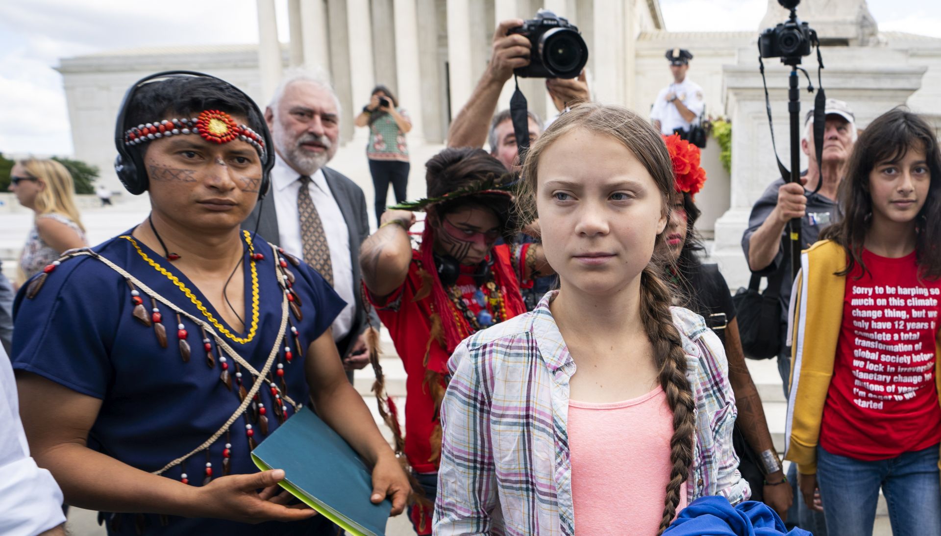 epa07851279 Sixteen-year-old climate activist Greta Thunberg (C) walks outside the US Supreme Court after watching a press conference in Washington, DC, USA, 18 September 2019. Earlier in the day, Thunberg testified about the climate crisis on Capitol Hill.  EPA/JIM LO SCALZO