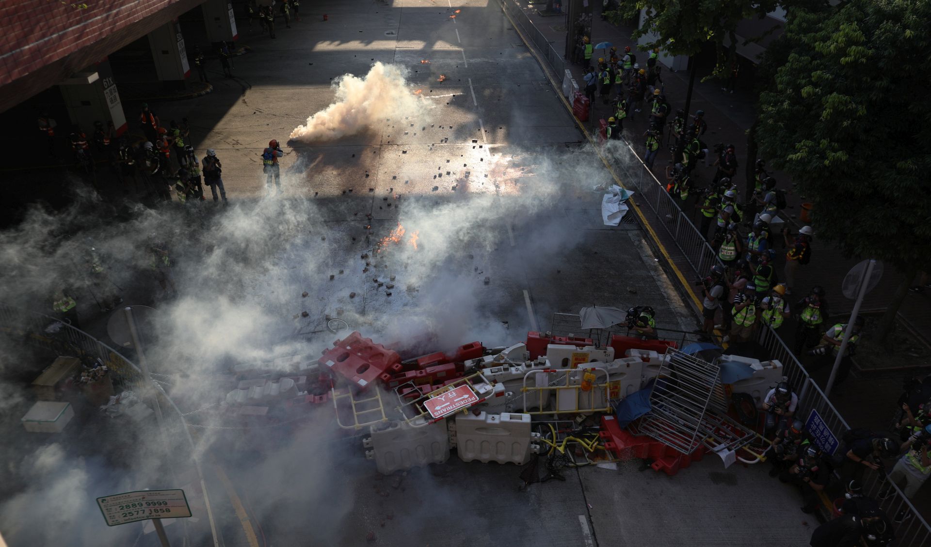 epa07858359 Riot police fire tear gas at protesters during an anti-government rally in Tuen Mun, Hong Kong, China, 21 September 2019. Hong Kong has entered its fourth month of mass protests, originally triggered by a now suspended extradition bill to mainland China that have turned into a wider pro-democracy movement.  EPA/JEROME FAVRE