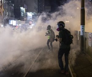 epa07859773 Members of the media photograph tear gas fired by riot police to disperse protesters in Yuen Long district, Hong Kong, China, 21 September 2019. Hong Kong has entered its fourth month of mass protests, originally triggered by a now suspended extradition bill to mainland China that have turned into a wider pro-democracy movement.  EPA/CHAN LONG HEI