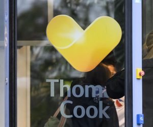 23 September 2019, Hessen, Oberursel: A woman goes to the headquarters of the German branch of the British travel group Thomas Cook. Thomas Cook, one of Britain's biggest travel firms, filed for liquidation early Monday, ceasing all trading with immediate effect, a move that could potentially leave thousands of holidaymakers stranded. Photo: Silas Stein/dpa