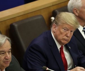 epa07864538 US President Donald J. Trump (C) is seen writing on a piece of paper while listening to United Nations Secretary General Antonio Guterres' (L) remarks at the United Nations for a global call to protect religious freedom with US Vice President Mike Pence (R) ahead of the General Debate of the General Assembly of the United Nations at United Nations Headquarters in New York, New York, USA, 23 September 2019. The General Debate of the 74th session of the UN General Assembly begins on 24 September.  EPA/JASON SZENES