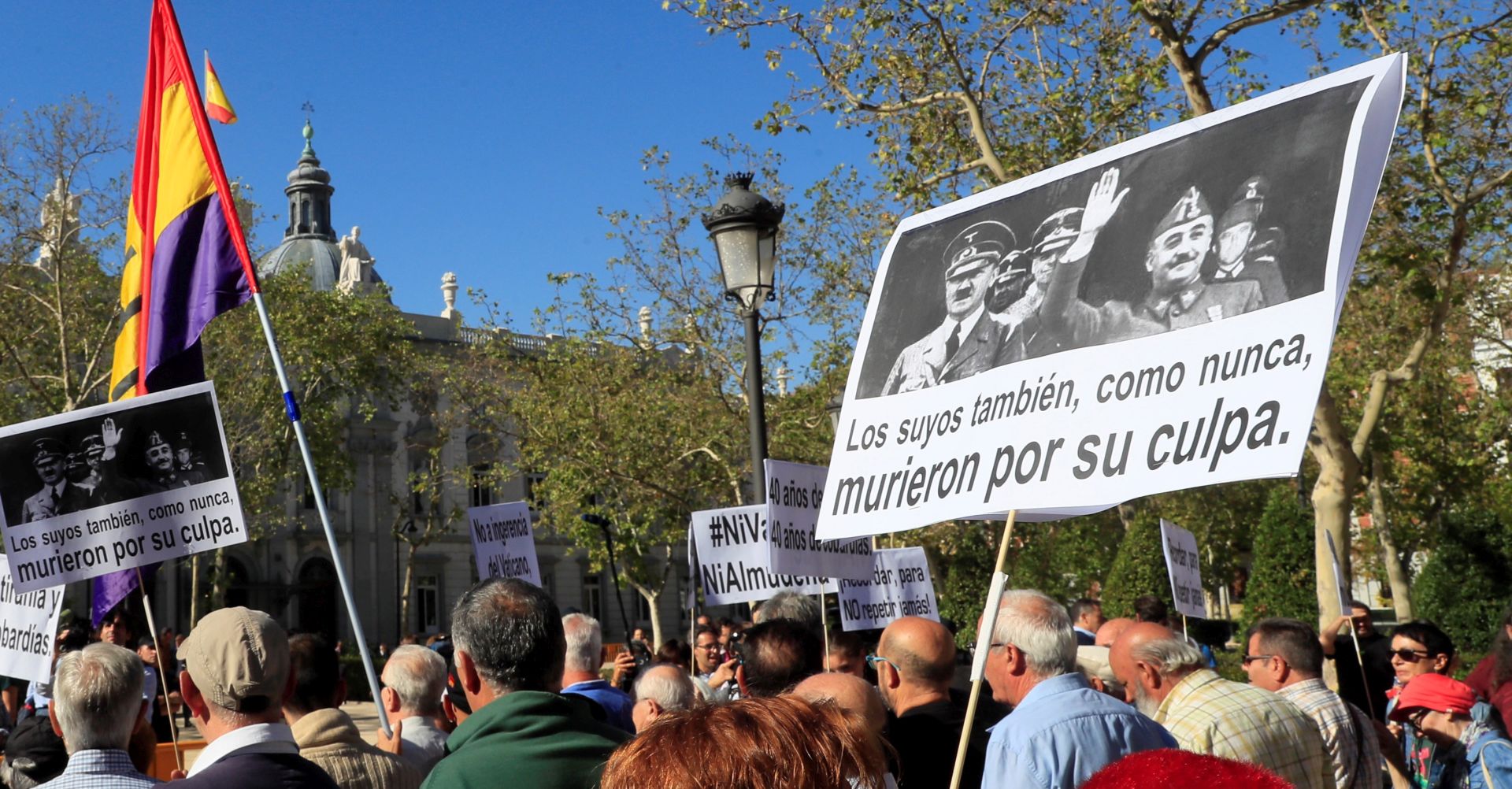 epa07865490 Protesters hold a banner with a picture of Spanish late dictator Francisco Franco (R) and German late dictator Adolf Hitler (L) that reads 'Their people also died because of their fault' during a protest at the Supreme Court in Madrid, Spain, to support the Government's decision of exhuming Franco's remains. The Supreme Court has endorsed a Royal Decree passed by the socialist Government, 24 August 2018, to modify the Spanish Historic Memory Law in order to allow the exhumation of Spanish dictator Francisco Franco's body from the memorial. El Valle de los Caidos is a controversial memorial complex that Franco decided to build back in 1940 to bury soldiers of the Nationalist faction fallen during the Civil War. It was years later, before its opening, when it was decided that soldiers from both sides should be buried at the memorial that was finally finished in 1959. Franco has been buried at the memorial since his death in 1975. According to the Supreme Court's ruling, Franco will have to be buried in a cemetery near Madrid, against his family's will that had the intention of burying him in the Spanish capital's city center.  EPA/Fernando Alvarado
