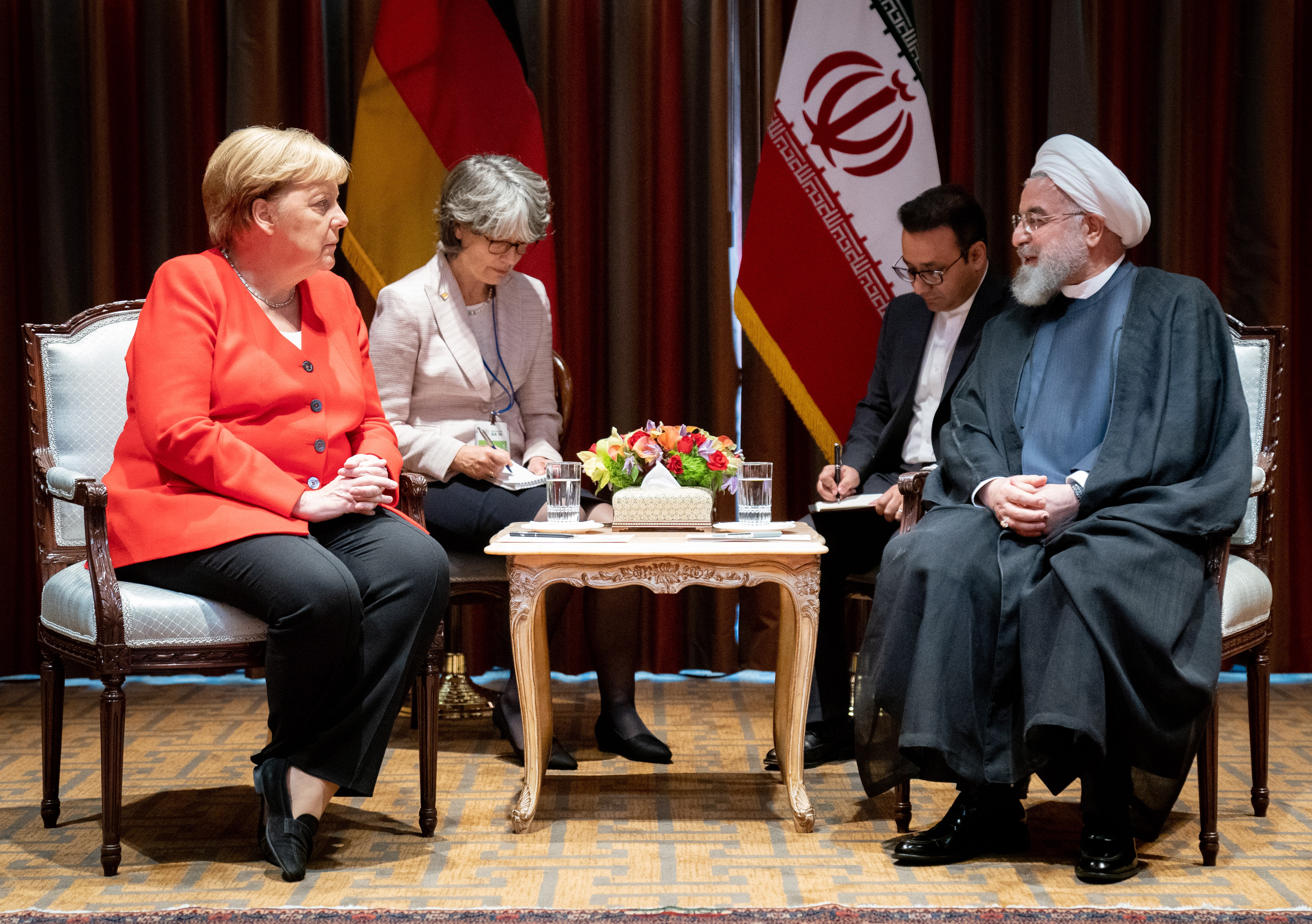 epa07866772 German Chancellor Angela Merkel (L) meets President of Iran Hassan Rouhani during their meeting on the sidelines of the general debate of the 74th session of the General Assembly of the United Nations at United Nations Headquarters in New York, New York, USA, 24 September 2019.  EPA/KAY NIETFELD / POOL