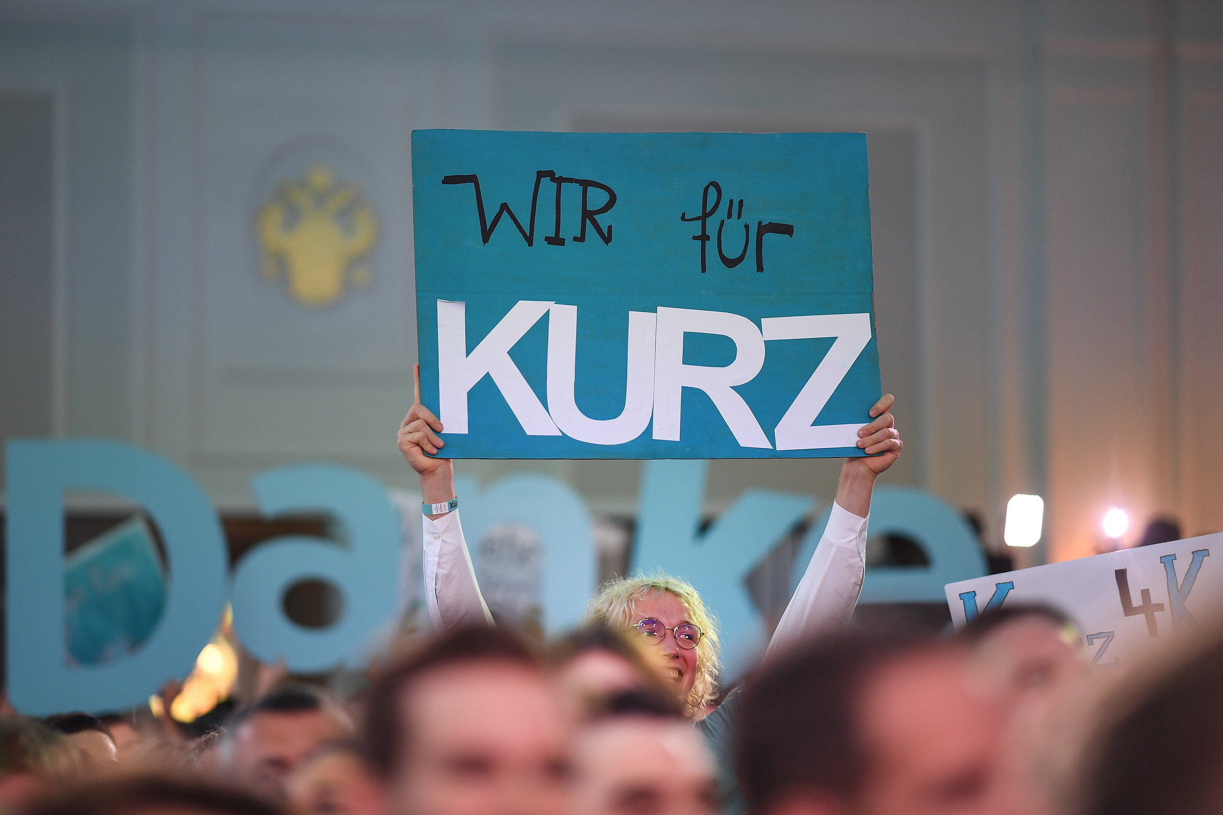 epa07880045 An Austrian People's Party (OeVP) supporter holds a sign reading 'We for Kurz' at an OeVP election party during the Austrian federal elections in Vienna, Austria, 29 September 2019. Projections published after the polls closed saw the OeVP as the clear winner of the general election  EPA/CHRISTIAN BRUNA