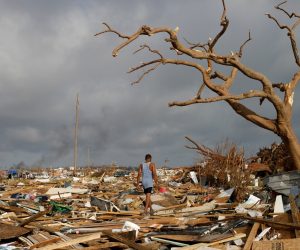 A man walks among debris at the Mudd neighborhood, devastated after Hurricane Dorian hit the Abaco Islands in Marsh Harbour A man walks among debris at the Mudd neighborhood, devastated after Hurricane Dorian hit the Abaco Islands in Marsh Harbour, Bahamas, September 6, 2019. REUTERS/Marco Bello     TPX IMAGES OF THE DAY Marco Bello