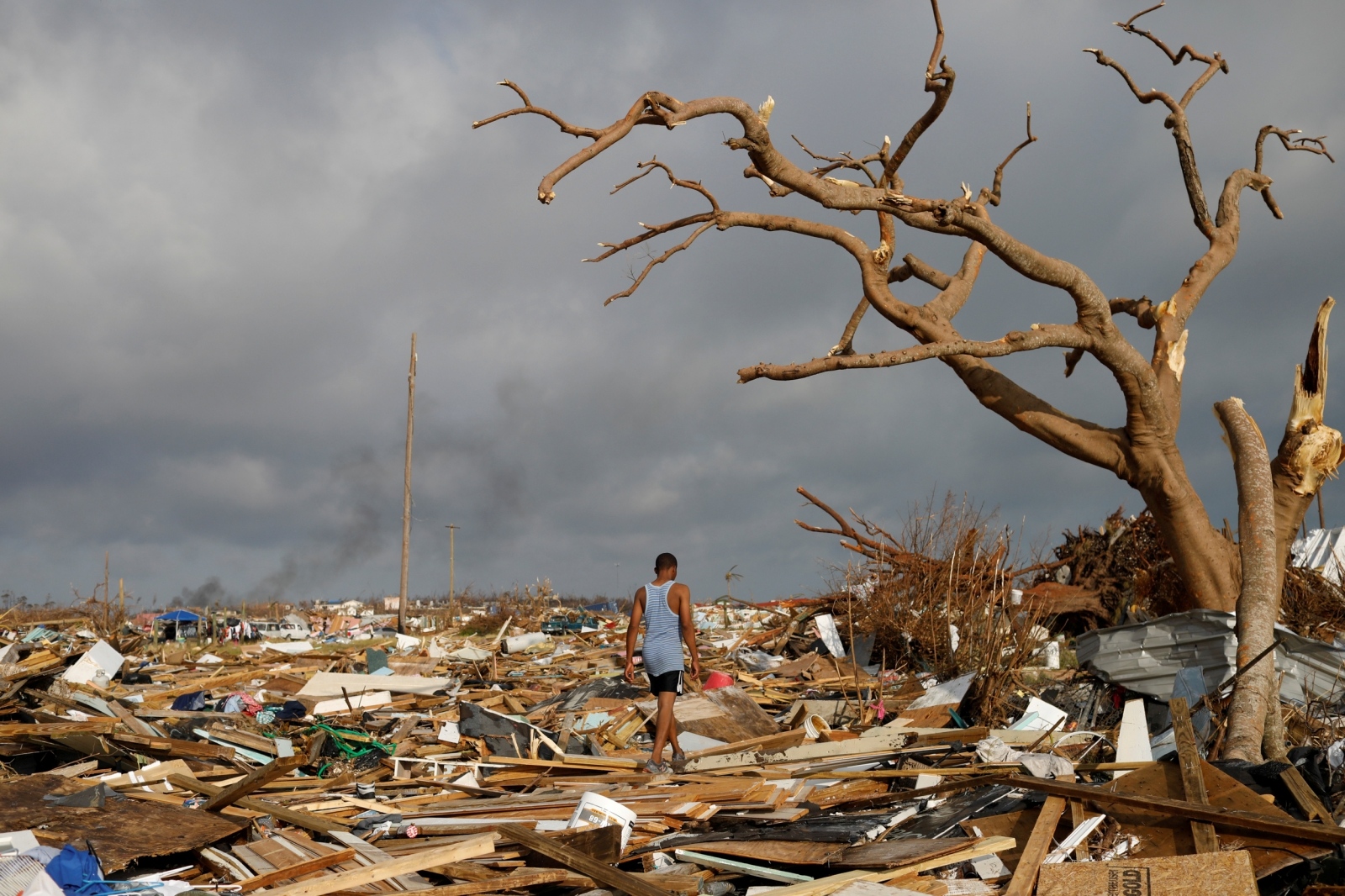 A man walks among debris at the Mudd neighborhood, devastated after Hurricane Dorian hit the Abaco Islands in Marsh Harbour A man walks among debris at the Mudd neighborhood, devastated after Hurricane Dorian hit the Abaco Islands in Marsh Harbour, Bahamas, September 6, 2019. REUTERS/Marco Bello     TPX IMAGES OF THE DAY Marco Bello