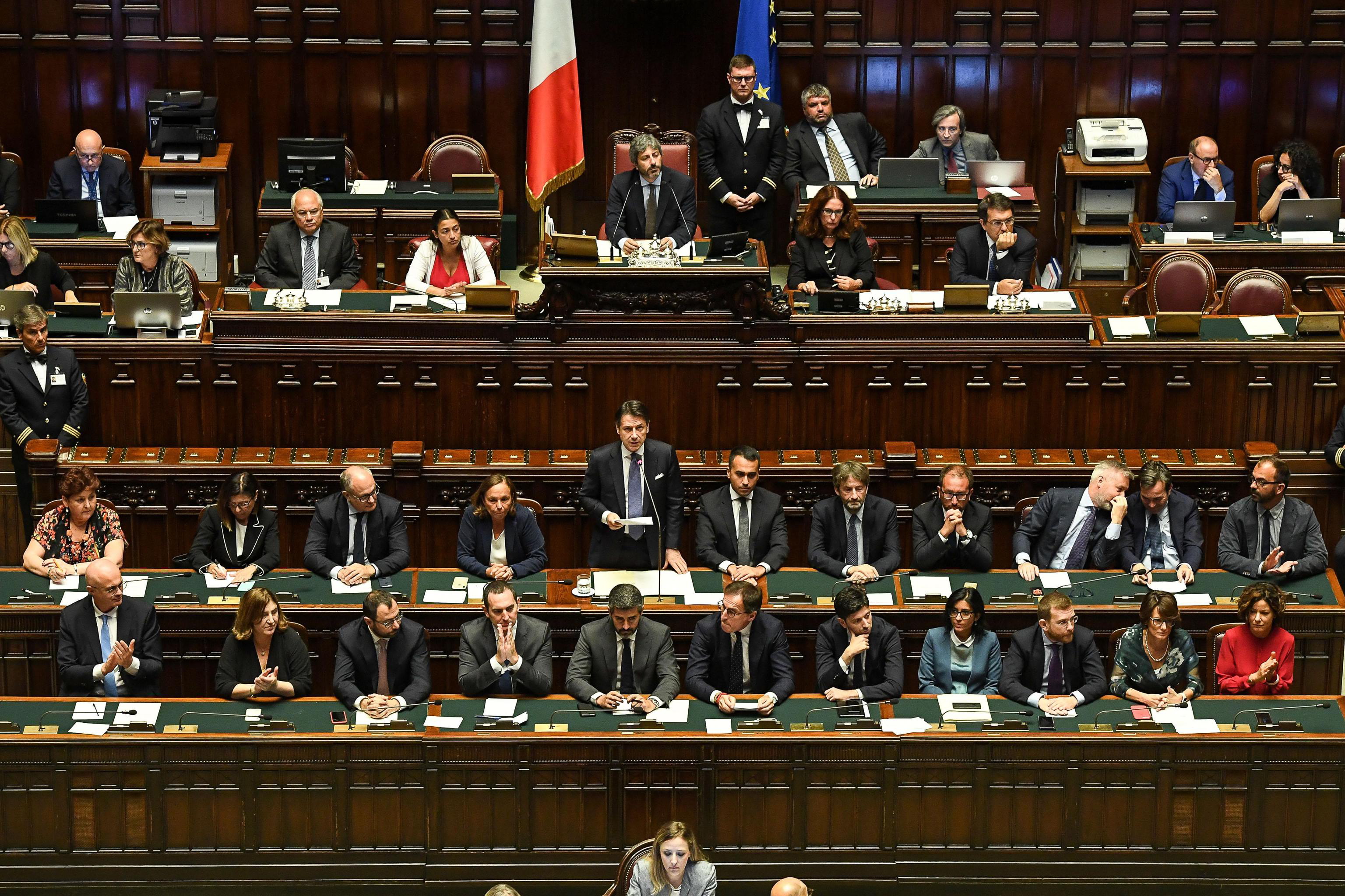 epa07829576 Italian Premier Giuseppe Conte (C) stands during his address to the Lower House ahead of a confidence vote, in Rome, Italy, 09 September 2019. Conte presented on the day his new government's programme in the Lower House ahead of the first of two confidence votes that the executive is set to face in parliament. His new government is a coalition between the anti-establishment 5-Star Movement (M5S) and the center-left Democratic Party (PD).  EPA/ALESSANDRO DI MEO