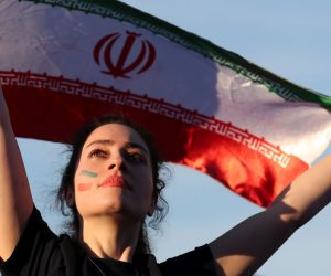 epa07853276 (FILE) - A woman holds up Iran's national flag as she watches a FIFA World Cup 2018 preliminary soccer match in the FIFA fan zone in Moscow, Russia, 15 June 2018 (reissued 19 September 2019). FIFA president Gianni Infantino on 19 September 2019 released a statement calling for women to be allowed into football stadiums in Iran. The statement added that the situation is 'unacceptable' and that FIFA is expecting positive developments from the Iranian Football Federation (FFIRI) and Iranian authorities starting by the next Iran home match in October 2019. Iran has barred women from attending sports stadiums after its 1979 Islamic Revolution.  EPA/ZURAB KURTSIKIDZE *** Local Caption *** 54410742