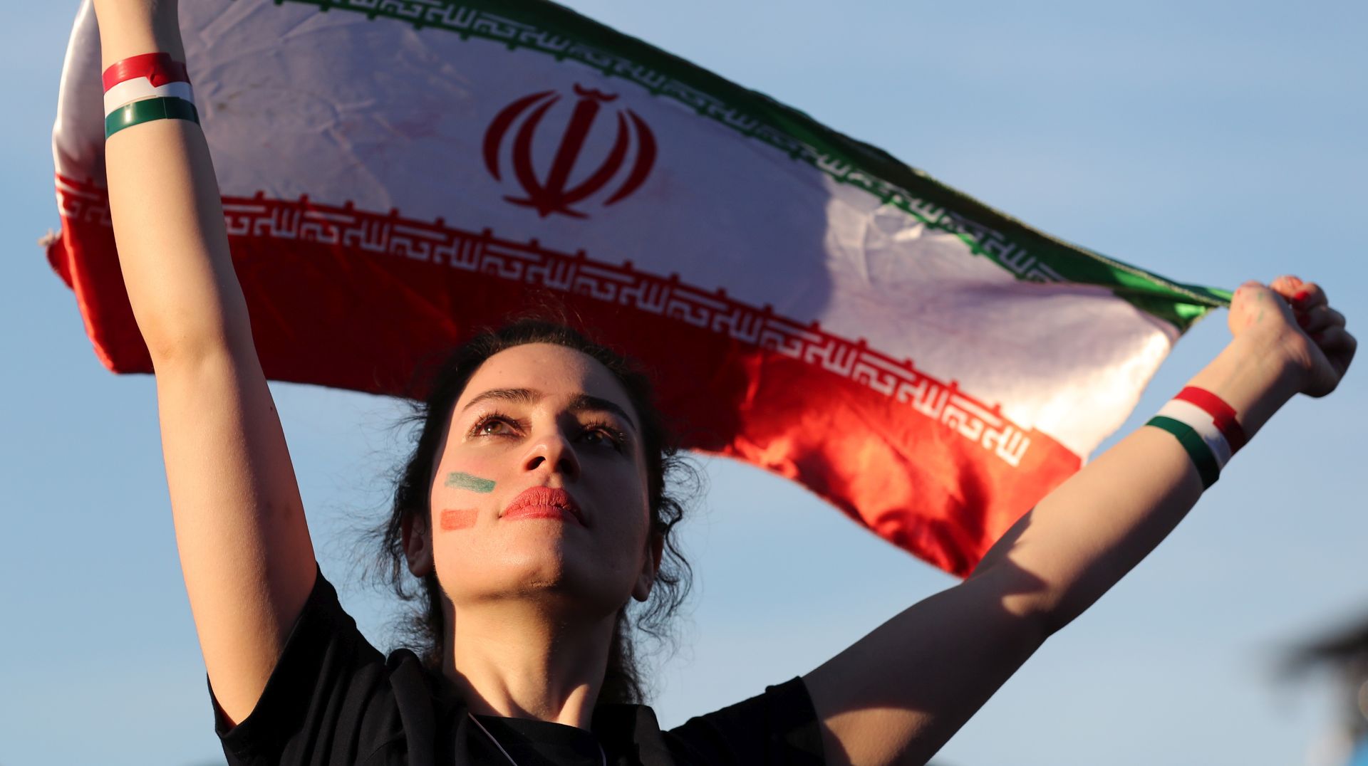 epa07853276 (FILE) - A woman holds up Iran's national flag as she watches a FIFA World Cup 2018 preliminary soccer match in the FIFA fan zone in Moscow, Russia, 15 June 2018 (reissued 19 September 2019). FIFA president Gianni Infantino on 19 September 2019 released a statement calling for women to be allowed into football stadiums in Iran. The statement added that the situation is 'unacceptable' and that FIFA is expecting positive developments from the Iranian Football Federation (FFIRI) and Iranian authorities starting by the next Iran home match in October 2019. Iran has barred women from attending sports stadiums after its 1979 Islamic Revolution.  EPA/ZURAB KURTSIKIDZE *** Local Caption *** 54410742