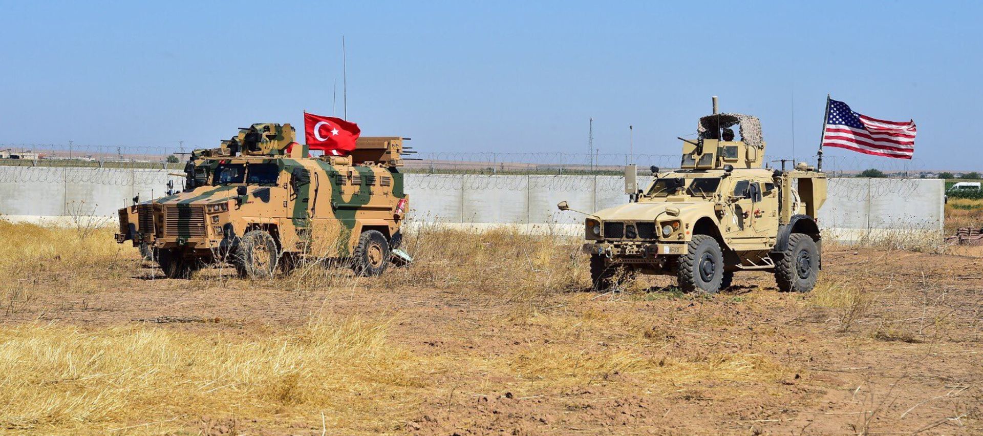 epa07865128 A handout photo made available by the Turkish Minister of Defence Press Office shows Turkish army vehicles driving back to Turkish territories after taking part in the second Turkish and US army ground patrol in Northern Syria, in Tal Abyad city, near Akcakale district in Sanliurfa, Turkey, 24 September 2019. Turkey and the US began joint patrols in northern Syria in order to establish a safe zone.  EPA/TURKISH MINISTRY OF DEFENCE HANDOUT  HANDOUT EDITORIAL USE ONLY/NO SALES