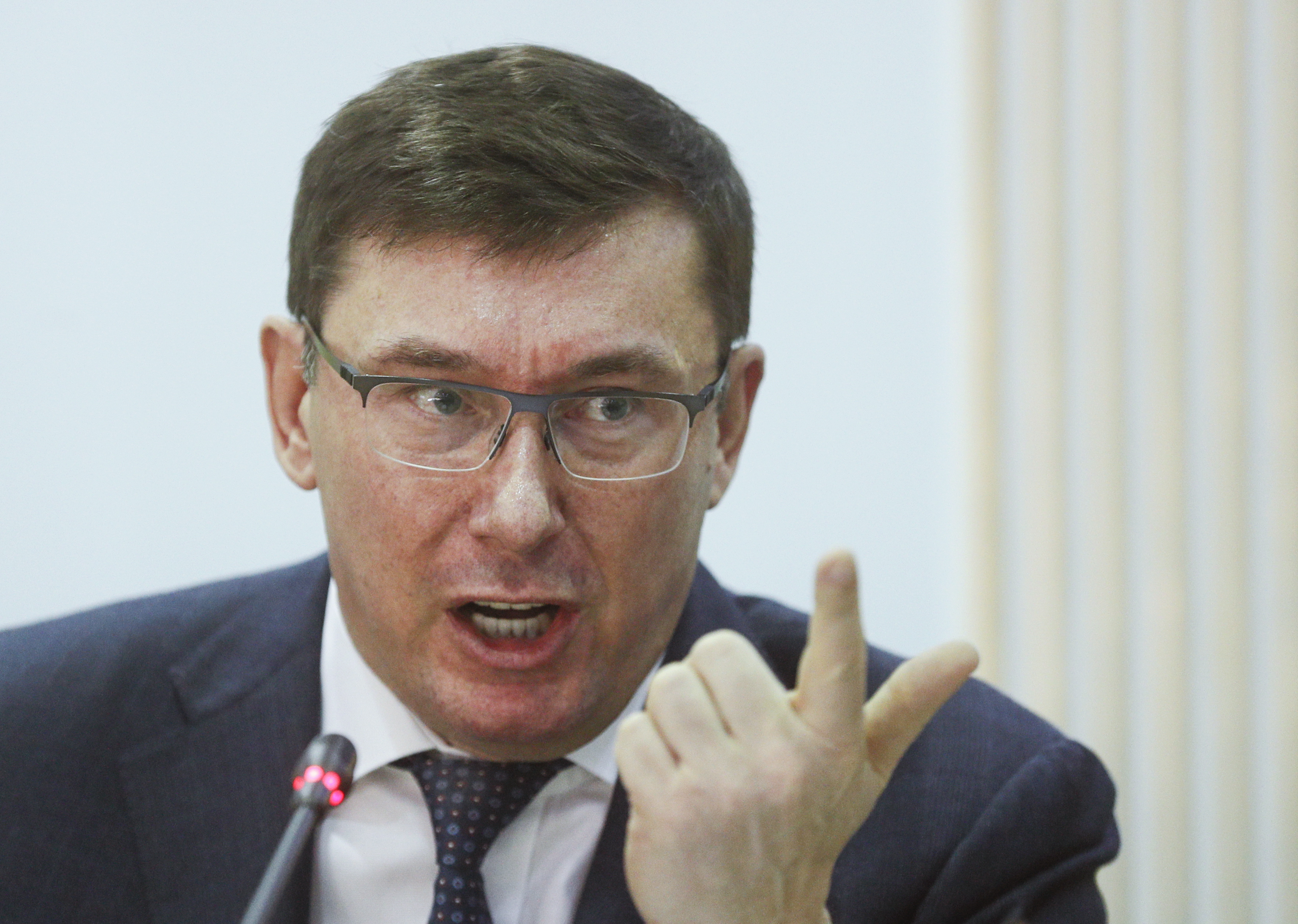 epa07872965 (FILE) - Yuriy Lutsenko, then Prosecutor General of Ukraine reacts during a joint briefing at the Central Election Committee office in Kiev, Ukraine, 12 March 2019 (reissued 27 September 2019). Meetings between Lutsenko and US President Trump's lawyer Rudy Giuliani are mentioned in a whistleblower's complaint over Trump's dealings with Ukraine. The whistleblower alleges that Trump had demanded Ukrainian investigations into US Presidential candidate Joe Biden and his son Hunter Biden's business involvement in Ukraine. *** Local Caption *** 55048052  EPA/SERGEY DOLZHENKO *** Local Caption *** 55048052