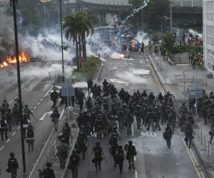 epa07885170 Police try to invade a road occupied by anti-government protesters during a protest on National Day in Hong Kong, China, 01 October 2019. Hong Kong has witnessed several months of ongoing mass protests, originally triggered by a now withdrawn extradition bill to mainland China that have turned into a wider pro-democracy movement.  EPA/JEROME FAVRE