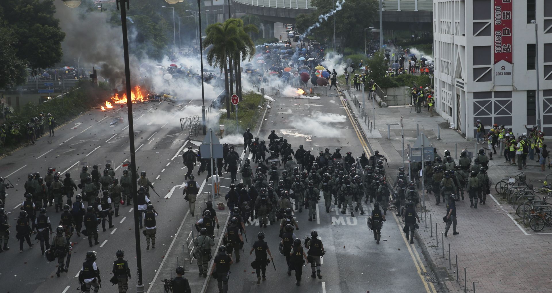 epa07885170 Police try to invade a road occupied by anti-government protesters during a protest on National Day in Hong Kong, China, 01 October 2019. Hong Kong has witnessed several months of ongoing mass protests, originally triggered by a now withdrawn extradition bill to mainland China that have turned into a wider pro-democracy movement.  EPA/JEROME FAVRE