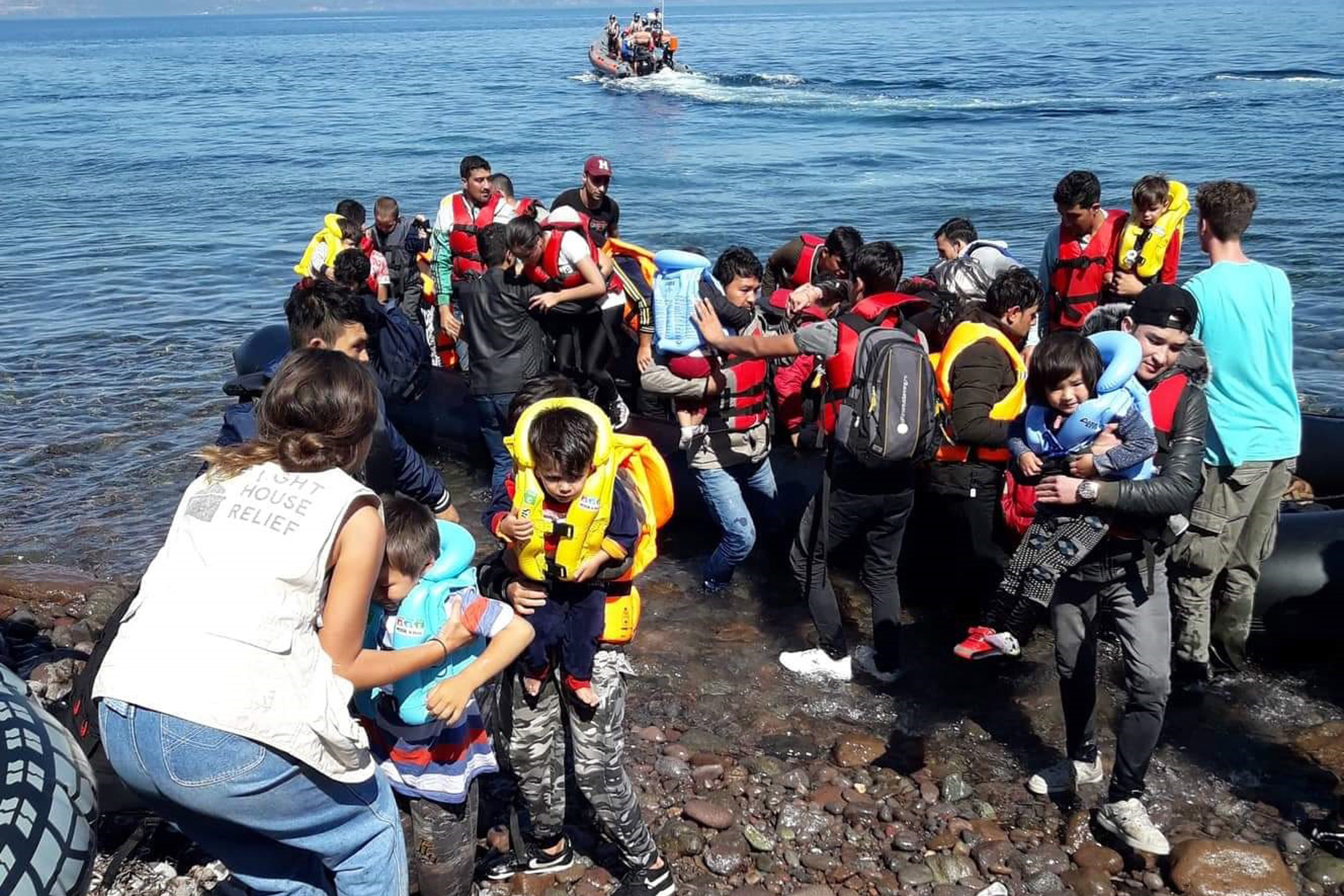 epaselect epa07886412 Migrants from Afghanistan arrive on a dinghy on the coast of Skala Sikamias, on the island of Lesvos, Greece, 01 October 2019.  EPA/STRATIS BALASKAS