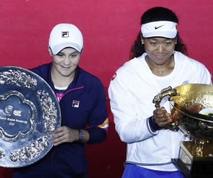 epa07900804 Naomi Osaka of Japan (R) celebrates with the trophy after winning her women's singles final against Ashleigh Barty of Australia (L) at the China Open tennis tournament in Beijing, China, 06 October 2019.  EPA/WU HONG
