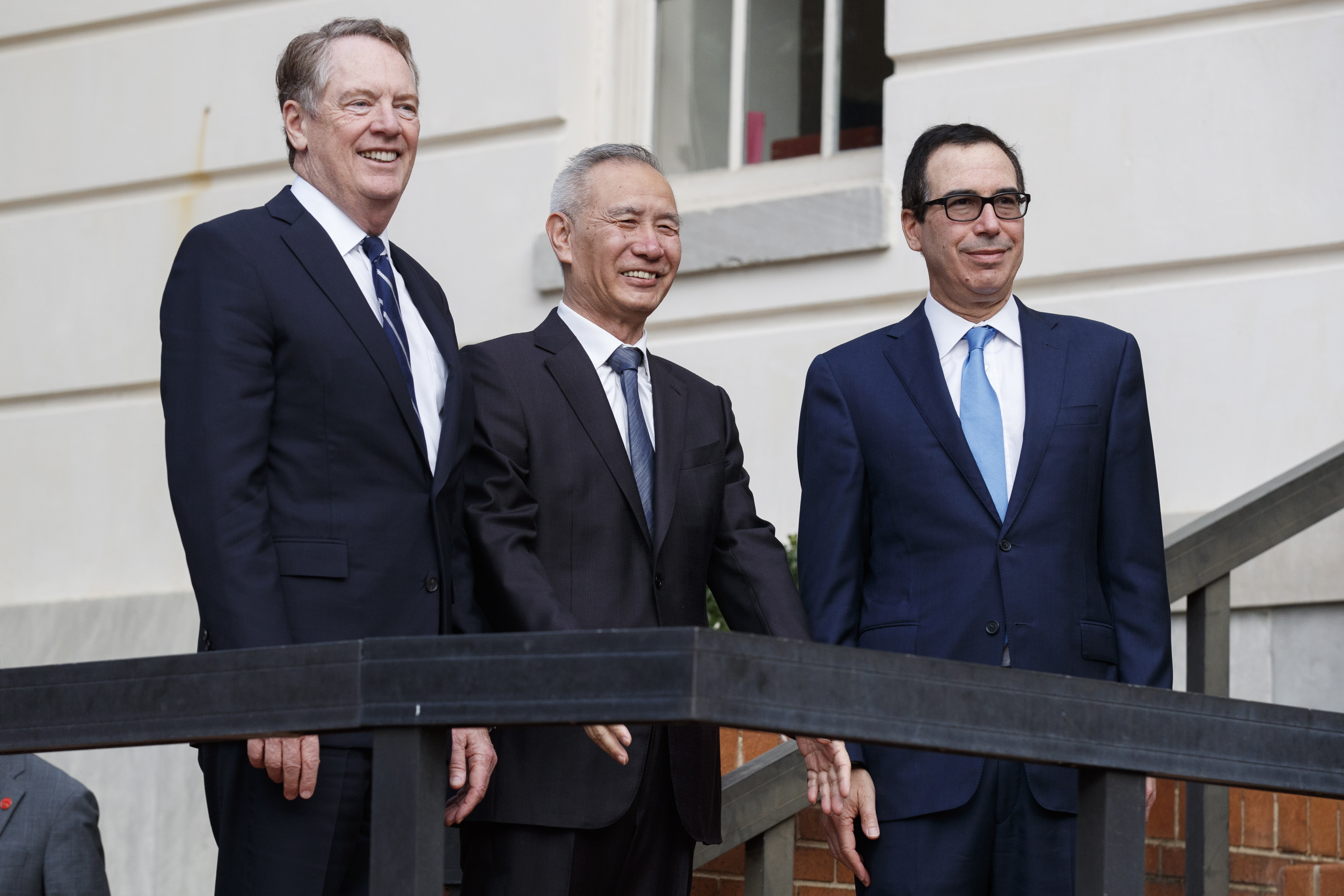 epa07910142 US Secretary of the Treasury Steven Mnuchin (R) and US Trade Representative Robert Lighthizer (L) greet Vice Premier of the People's Republic of China Liu He (C) prior to negotiations at the office of the US Trade Representative in Washington, DC, USA, 10 October 2019. The two nations' top trade negotiators are meeting for the first time since July and are attempting to negotiate an end to the US China trade war.  EPA/SHAWN THEW