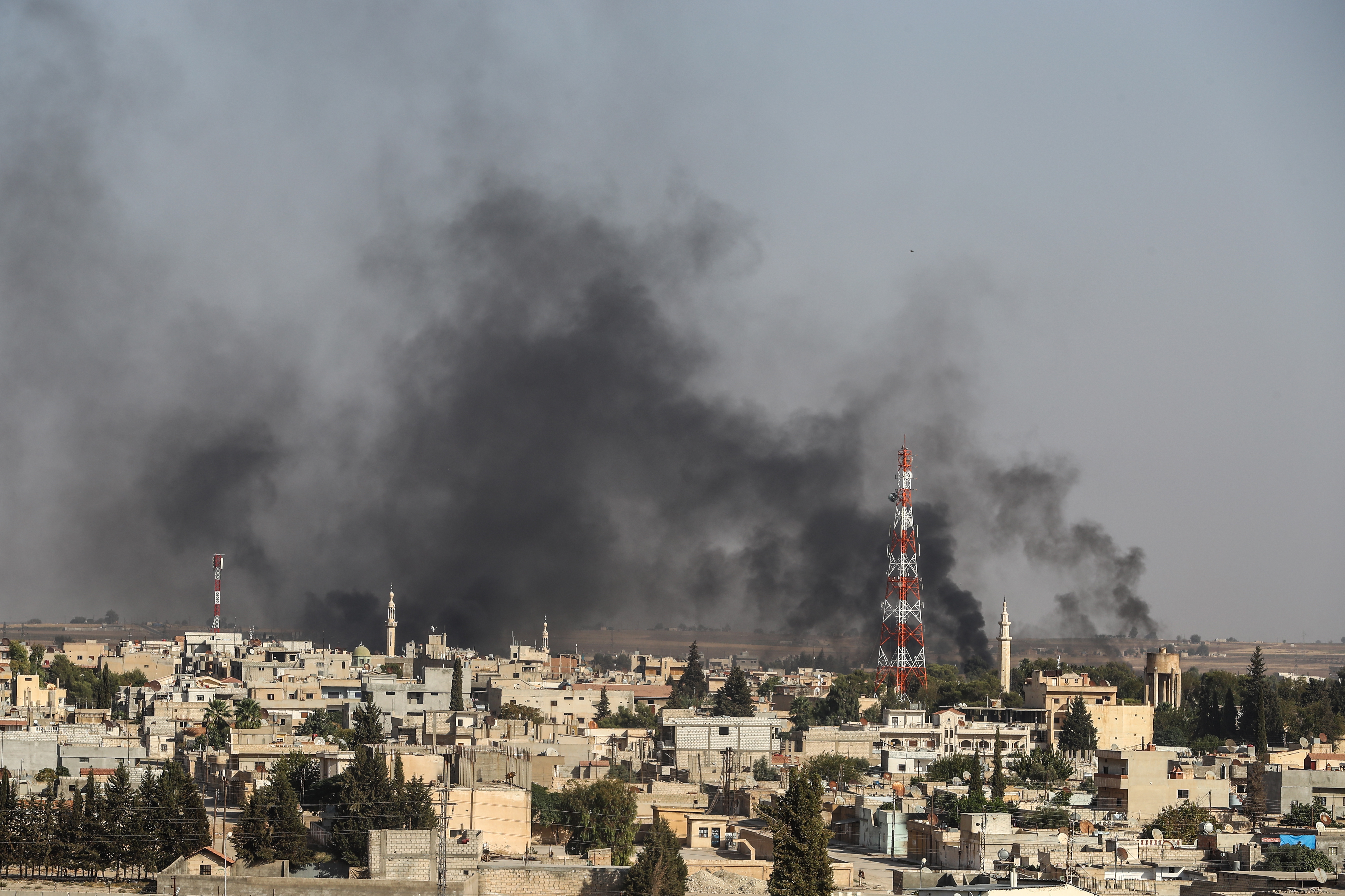 epa07910278 A picture taken from Turkish territory shows smoke rising from targets inside Syria during bombardment by Turkish forces at Ras al-Ein town, in Ceylanpinar, in Sanliurfa, Turkey 10 October 2019. Turkey has launched an offensive targeting Kurdish forces in north-eastern Syria, days after the US withdrew troops from the area.  EPA/SEDAT SUNA