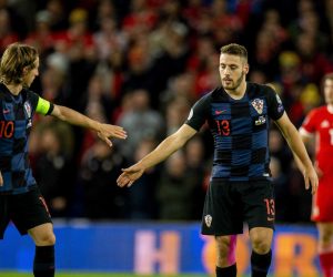epa07918807 Croatia's Nikola Vlasic (R) celebrates with teammate Luka Modric after scoring the first goal during the UEFA EURO 2020 group E qualifier soccer match between Wales and Croatia held at Cardiff City Stadium in Wales, Britain, 13 October 2019.  EPA/PETER POWELL