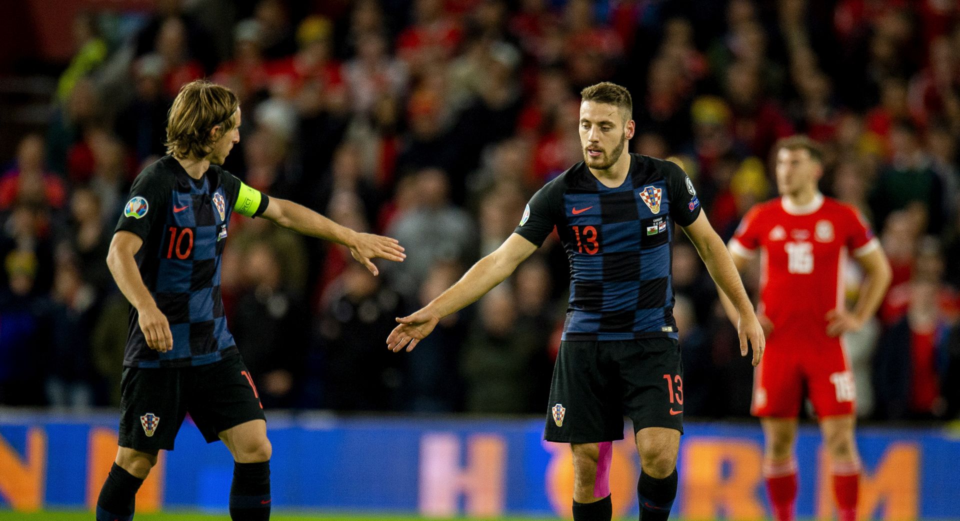 epa07918807 Croatia's Nikola Vlasic (R) celebrates with teammate Luka Modric after scoring the first goal during the UEFA EURO 2020 group E qualifier soccer match between Wales and Croatia held at Cardiff City Stadium in Wales, Britain, 13 October 2019.  EPA/PETER POWELL