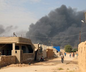 epa07927386 A general view showing smoke clouds rising from the scene of clashes between the Syria democratic forces (SDF) and Turkish troops and their Syrian opposition allies near Ras al-Ain town, northeastern of Syria on 17 October 2019. The Turkish offensive in northeastern Syria against Kurdish militants has displaced more than 300,000 people, human rights organizations said.  EPA/AHMED MARDNLI