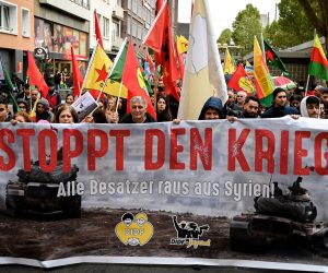 epa07933241 Kurdish activists wave flags and show banners as they protest against the ongoing Turkish military operation in the Syrian border region and the Kurdish territories, in Cologne, Germany, 19 October 2019. The protesters demanded economic sanctions and an arms embargo against Ankara as well as a termination of the EU-Turkey refugee agreement.  EPA/SASCHA STEINBACH