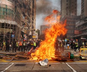 epa07935925 Flames rise from barricades that were set on fire during a rally to abolish the anti-mask law in Hong Kong, China, 20 October 2019. Hong Kong has witnessed several months of ongoing mass protests, originally triggered by a now withdrawn extradition that have turned into a wider pro-democracy movement.  EPA/JEROME FAVRE