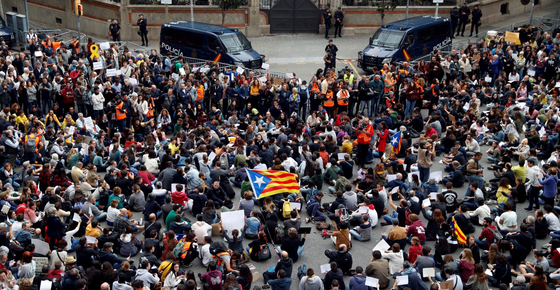 epa07938432 Protesters hold banners as they attend a sit-in protest outside Central Government's Headquarters in Catalonia, amid the visit of acting Spanish Prime Minister Sanchez, in Barcelona, Spain, 21 October 2019. The rally, called by the group Tsunami Democratic, is held in the framework of the Sanchez' s visit to the security forces officers who were admitted to hospitals in Barcelona after they were wounded in the riots in Barcelona. Catalonia region in Spain witnessed massive demonstrations and riots since the Spanish Supreme Court's 13 October ruling of prison terms against the Catalan political leaders accused of organizing the Catalan illegal referendum held in October 2017.  EPA/Toni Albir