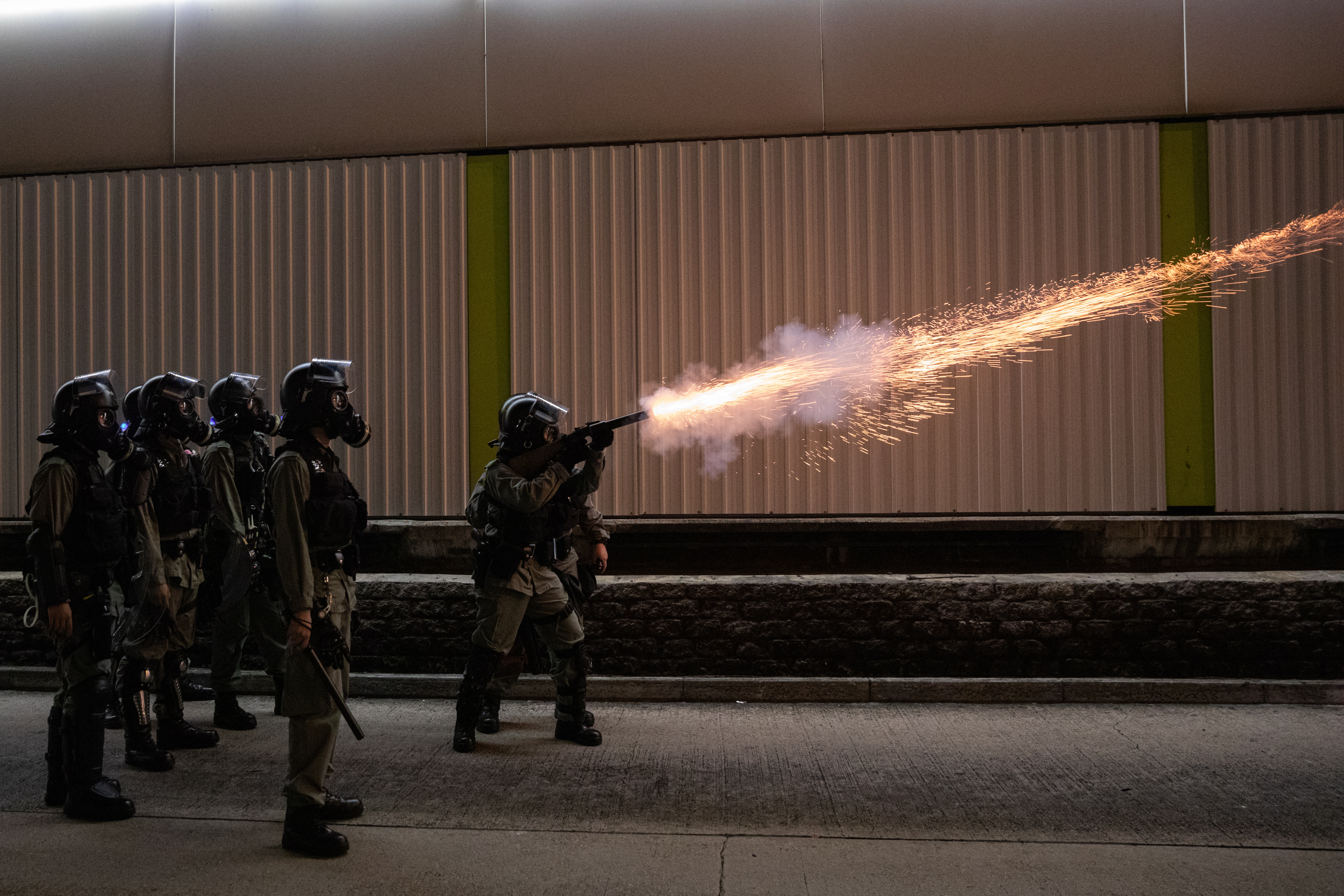 epa07938998 Police fire tear gas during a rally marking the third month anniversary of alleged triads members attacking protesters and residents in Yuen Long, New Territories, Hong Kong, China, 21 October 2019. Hong Kong has witnessed several months of ongoing mass protests, originally triggered by a now withdrawn extradition bill to mainland China that have turned into a wider pro-democracy movement.  EPA/JEROME FAVRE