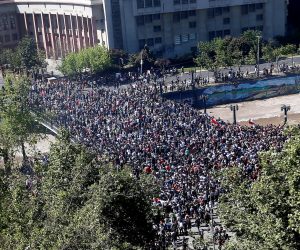 epa07939402 Demonstrators participate in a new day of mass protests at Plaza Italia, in Santiago, Chile, 21 October 2019. An unrest, sparked by a hike in metro fares, quickly morphed into a wider protest against social inequality. Chilean Army general Javier Iturriaga, responsible for security during the state of emergency decreed in Santiago, established on the same day the third curfew in the Chilean capital and the rest of the Metropolitan region due to the persistence of the riots.  EPA/Esteban Garay