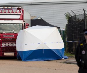epa07943119 Police officers cordon off the area with the lorry at the scene in Waterglade Industrial Park in Grays, Essex, Britain, 23 October 2019. A total of 39 bodies were discovered inside a lorry container in the early hours of this morning, and pronounced dead at the scene.  EPA/VICKIE FLORES