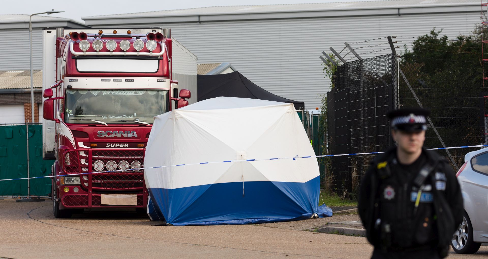 epa07943119 Police officers cordon off the area with the lorry at the scene in Waterglade Industrial Park in Grays, Essex, Britain, 23 October 2019. A total of 39 bodies were discovered inside a lorry container in the early hours of this morning, and pronounced dead at the scene.  EPA/VICKIE FLORES