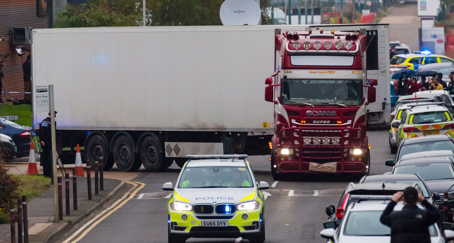 epaselect epa07943573 Police drive the lorry container along the road from the scene in Waterglade Industrial Park in Grays, Essex, Britain, 23 October 2019. A total of 39 bodies were discovered inside a lorry container in the early hours of this morning, and pronounced dead at the scene.  EPA/VICKIE FLORES