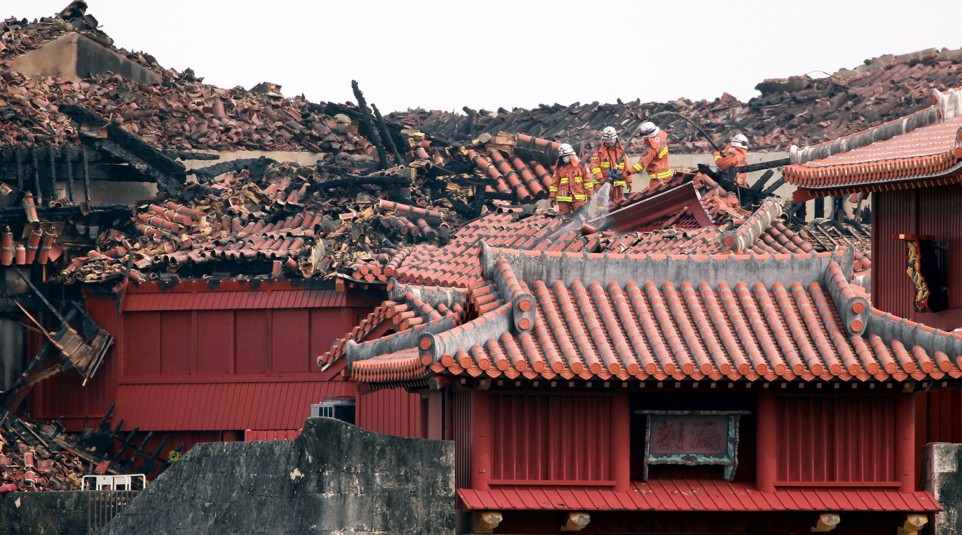 epa07961679 Firefighters inspect the heavily damaged Shuri Castle in Naha, Okinawa prefecture, Japan, 31 October 2019. On early 31 October, a fire started at Shuri Castle in Naha, a castle in Okinawa listed as a World Heritage site, destroying major buildings of the castle complex. The cause of the fire is still unknown and there is no report of injury.  EPA/HITOSHI MAESHIRO