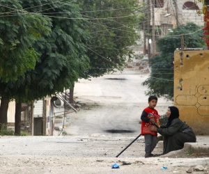 An elderly woman and a child are seen along a deserted street in the town of Ras al-Ain An elderly woman and a child are seen along a deserted street in the town of Ras al-Ain, Syria October 24, 2019. REUTERS/Aboud Hamam ABOUD HAMAM
