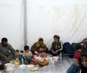 epa07938822 Syrian refugees eat after arriving at Bardarash refugee camp in South of Duhok, Kurdistan region, Iraq, 21 October 2019. According to camp officials, more than 1200 refugee arrived to the camp on 21 October after fleeing the Turkish military operation in Syria. Turkey has launched an offensive targeting Kurdish forces in north-eastern Syria on 09 October, days after the US withdrew troops from the area.  EPA/GAILAN HAJI