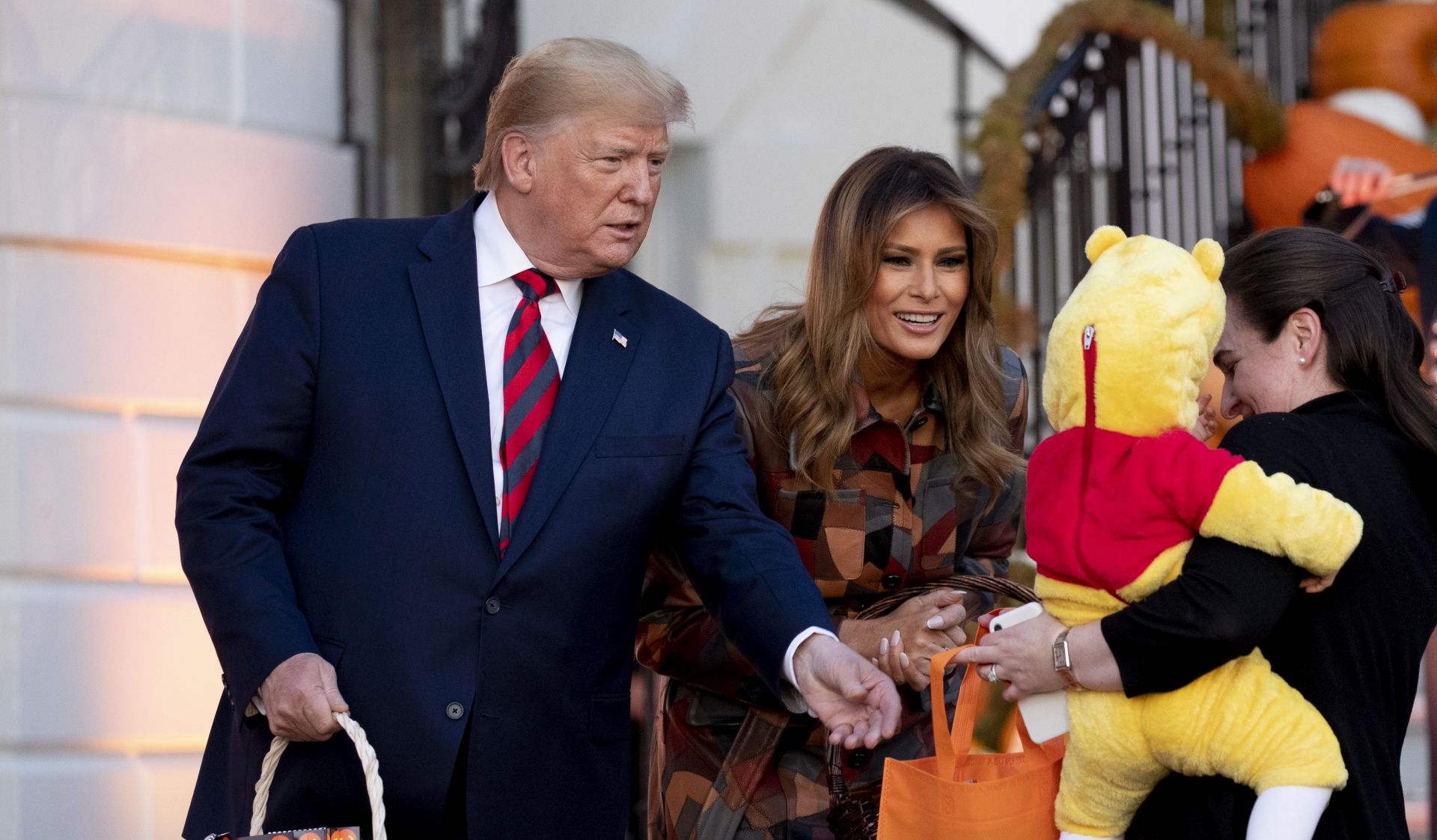epa07957146 US President Donald J. Trump (L) and First Lady Melania Trump (R) hand out candy to children in costumes during a Halloween event at the White House in Washington, DC, USA, 28 October 2019. Halloween is celebrated 31 October.  EPA/MICHAEL REYNOLDS