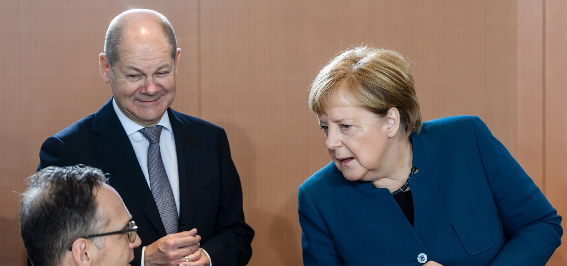 epa07975789 German Chancellor Angela Merkel (R) and German Foreign Minister Heiko Maas (L) talk next to German Minister of Finance Olaf Scholz (2-L) during the beginning of the weekly meeting of the German Federal cabinet at the Chancellery in Berlin, Germany, 06 November 2019. During the 47th cabinet meeting, the ministers and the Chancellor are expected to discuss, among other topics, the inventory of the implementation of the coalition contract.  EPA/CLEMENS BILAN