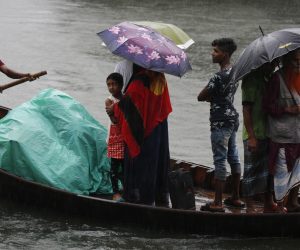 epa07983072 Bangladeshi passengers cover themselves with a plastic sheet and umbrellas as they cross the Buriganga River by boat during a rainy day in Dhaka, Bangladesh, 09 November 2019. According to the Bangladesh Inland Water Transport Authority (BIWTA) and Bangladesh Meteorology Department, the suspended inland water transport in approaching of Cyclone Bulbul, after the cyclone made landfall in the world's largest mangrove forest Sundarbans and passes through the coastal areas in Khulna and West Bengal state.  EPA/MONIRUL ALAM