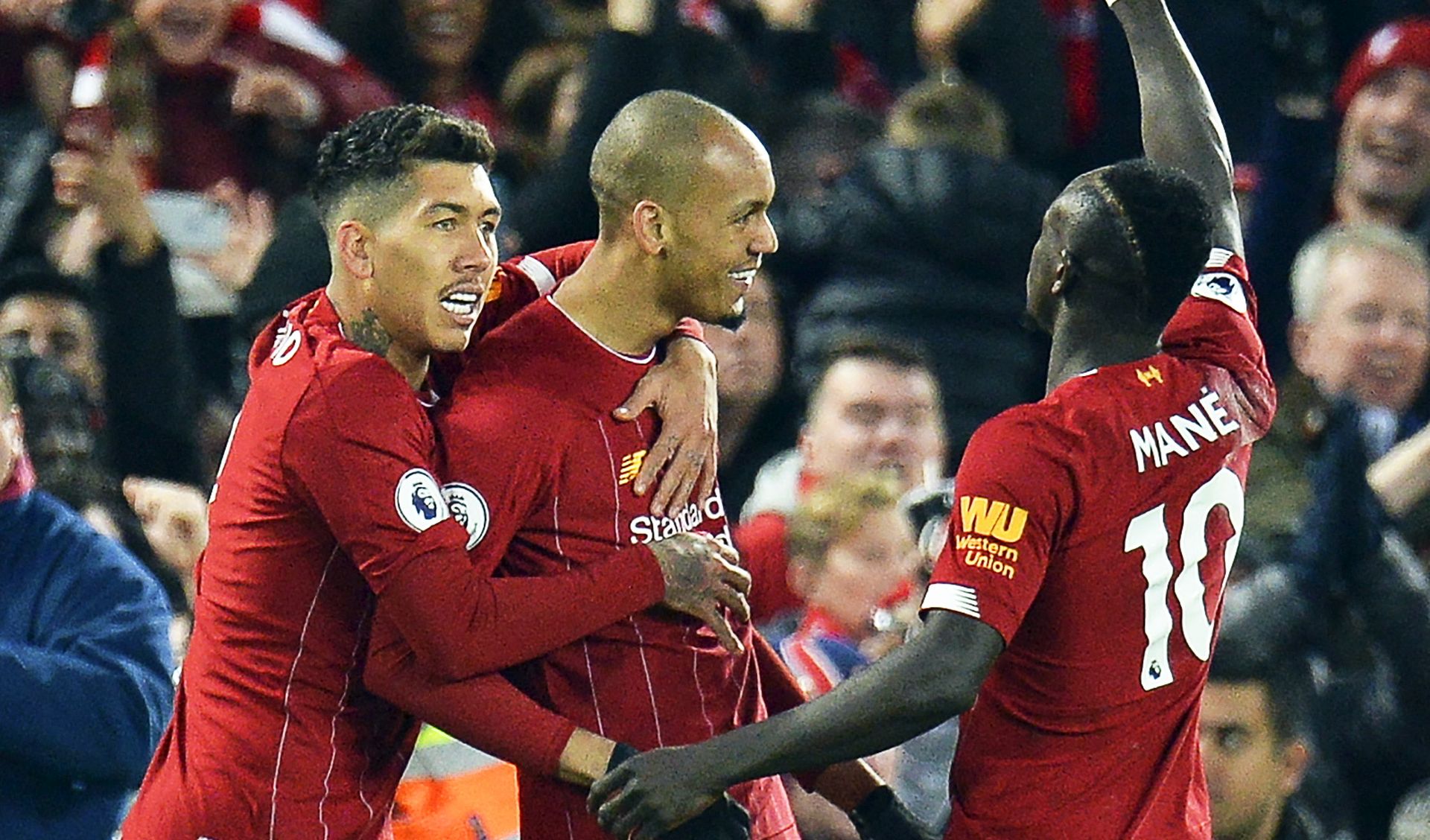 epa07986463 Fabinho (C) of Liverpool celebrates with teammates Roberto Firmino (L) and Sadio Mane (R) after scoring the 1-0 lead during the English Premier League soccer match between Liverpool FC and Manchester City in Liverpool, Britain, 10 November 2019.  EPA/PETER POWELL EDITORIAL USE ONLY. No use with unauthorized audio, video, data, fixture lists, club/league logos or 'live' services. Online in-match use limited to 120 images, no video emulation. No use in betting, games or single club/league/player publications